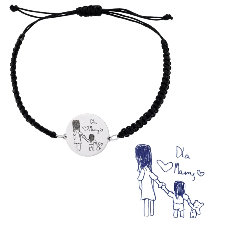 Bransoletka dla mamy z grawerem rysunku dziecka oraz kartka z oryginalnym szkicem obok. Personalizowany prezent, który łączy rysunek dziecka z trwałym grawerem na stali.